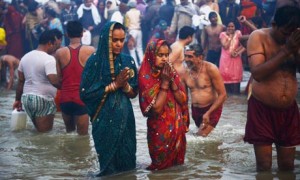 Hindu devotees pray as they bathe in the Sangham during the Kumbh Mela in Allahabad